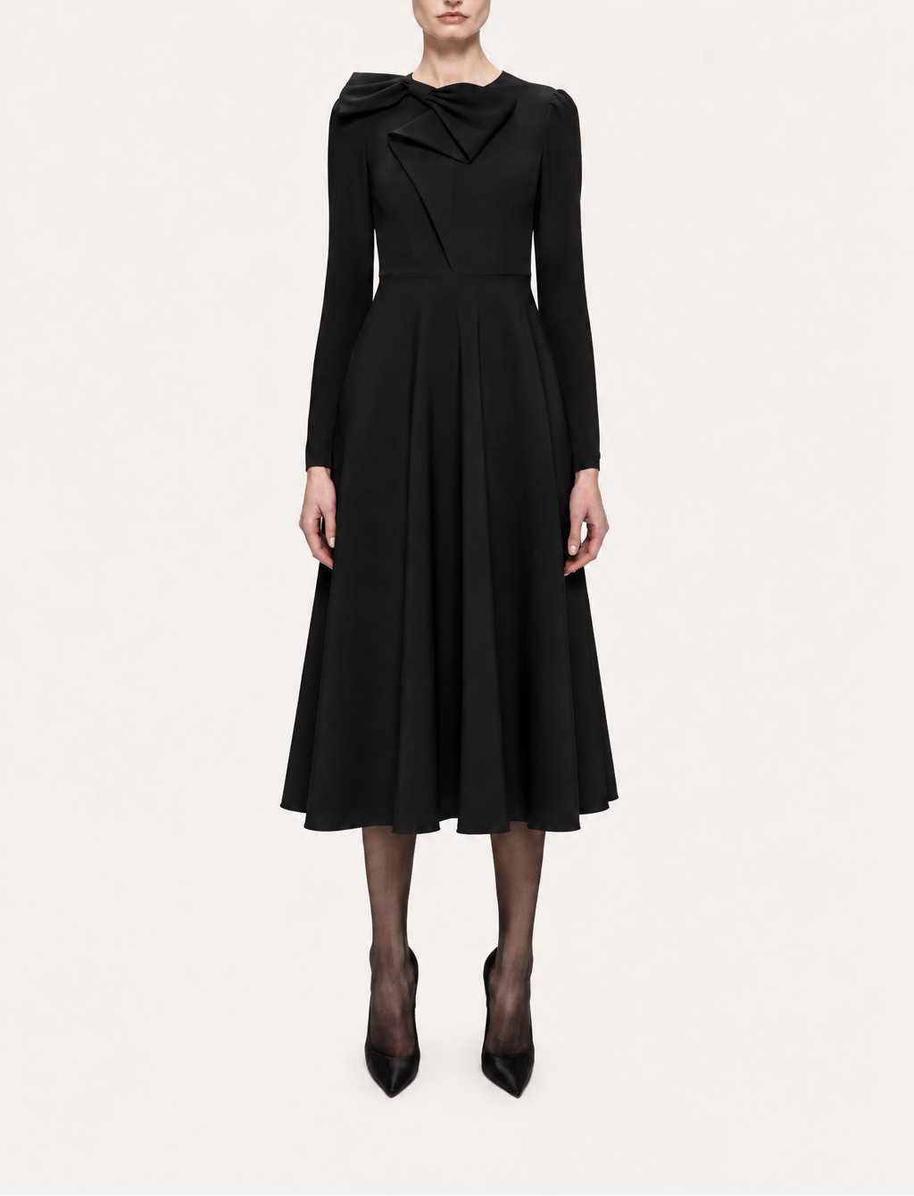 Front view of NISSA black bow-neck A-line midi dress with long sleeves and a defined waist, styled with black pumps.