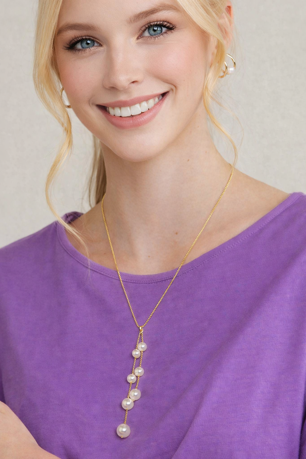 model wearing pearl lariat necklace gold chain faux pearl drop elegant pearl jewelry