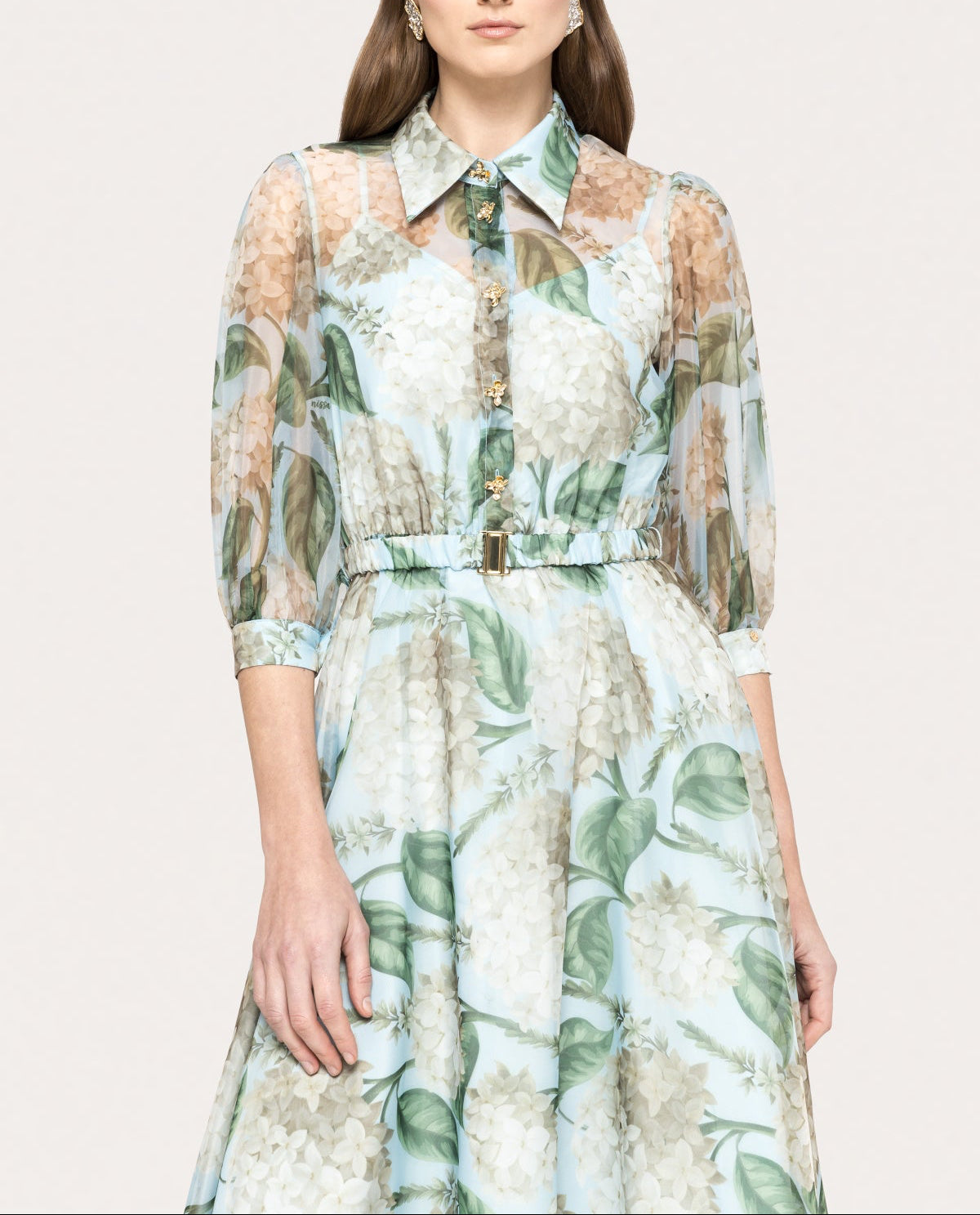 Close-up of floral organza midi dress with gold-tone floral buttons and structured collar neckline