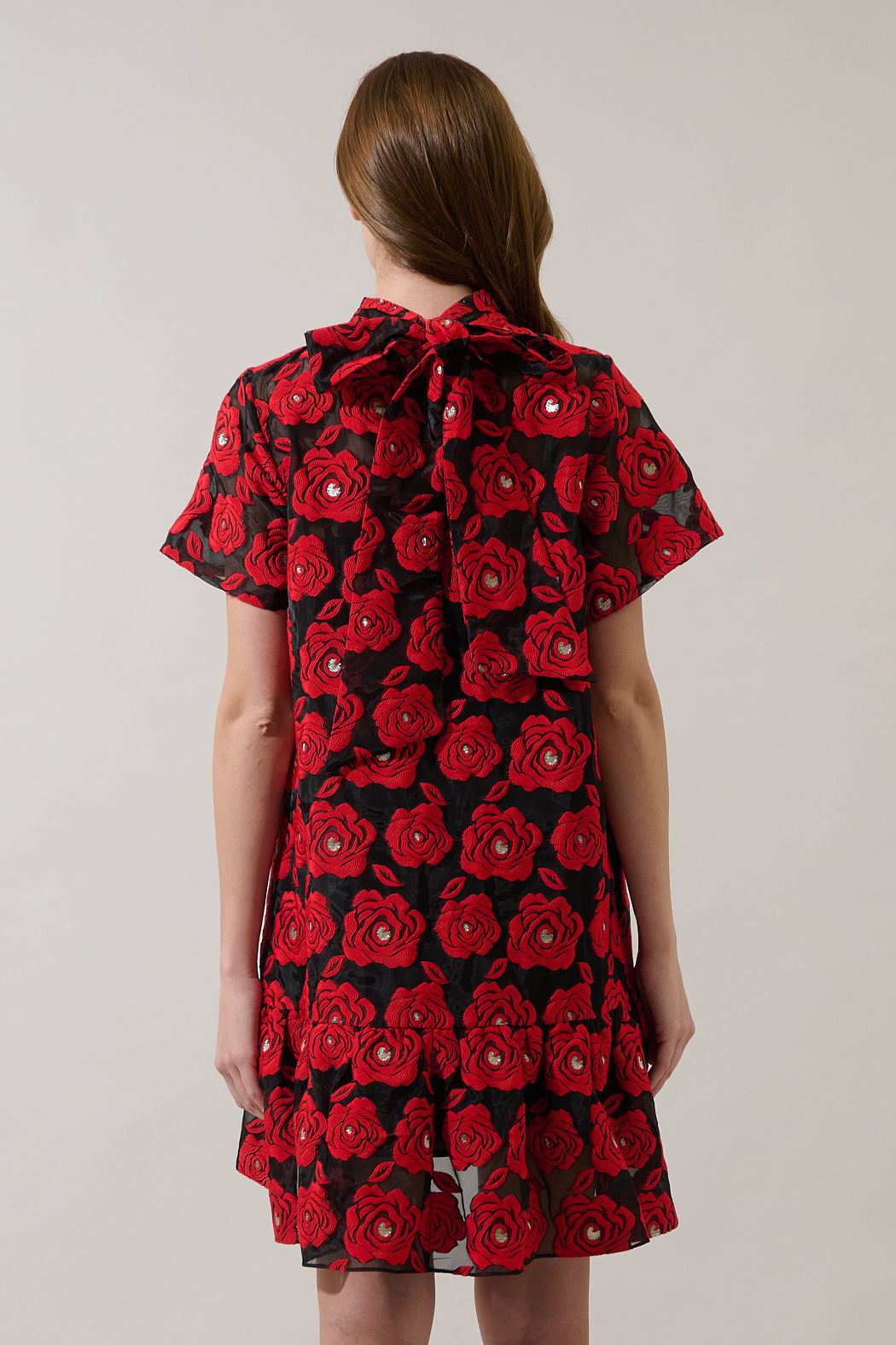 Back view of Sugarlips Berny red and black floral mini dress showing the neck bow and gathered ruffle hem