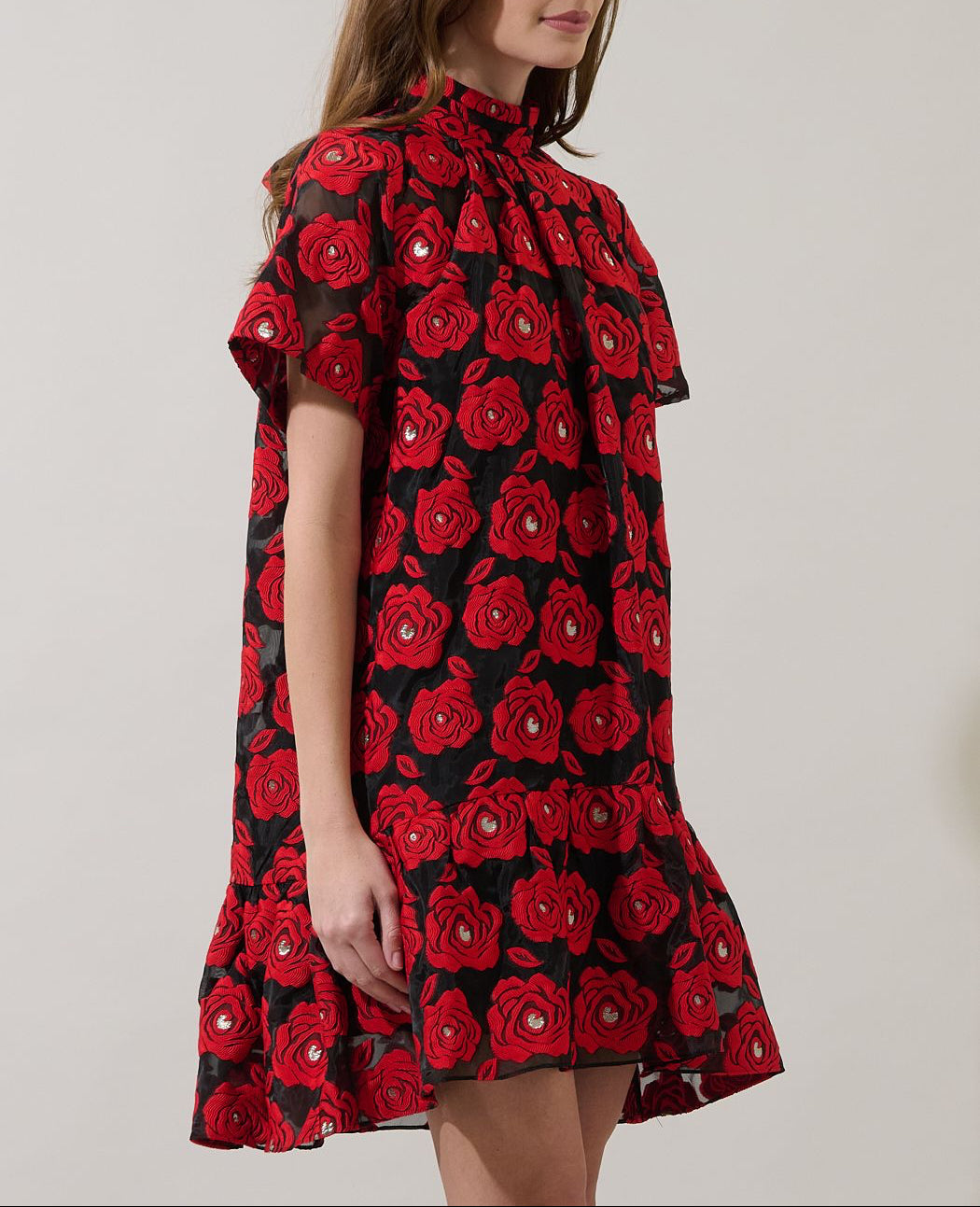Side view of Berny floral organza mini dress showing the relaxed silhouette, sheer short sleeves and ruffled hem