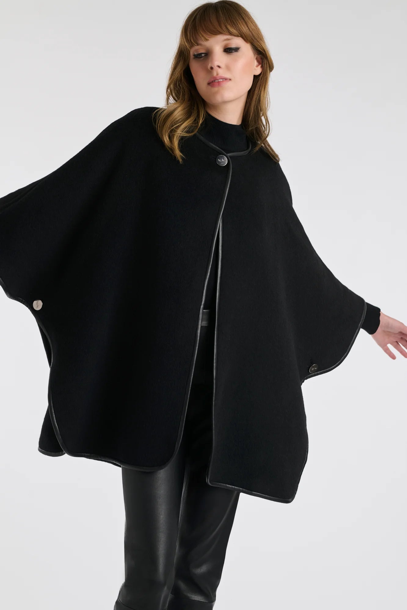 Woman wearing Black Reversible wool cape poncho