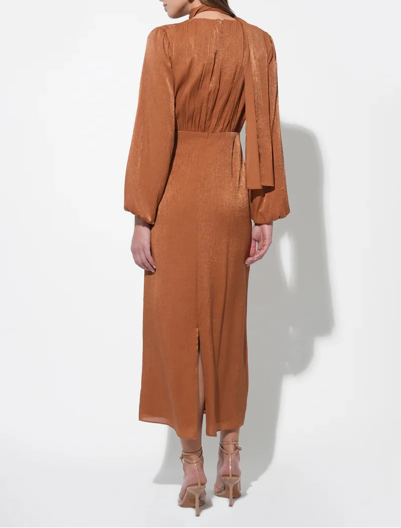 Back view of rust satin midi dress with gathered waist, long sleeves and back vent for movement