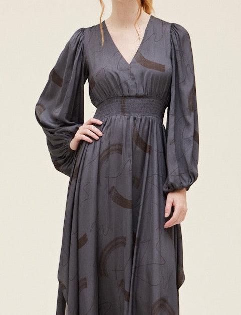 Grade & Gather Slate gray abstract satin dress showing the V-neck, smocked waist and long voluminous sleeves.