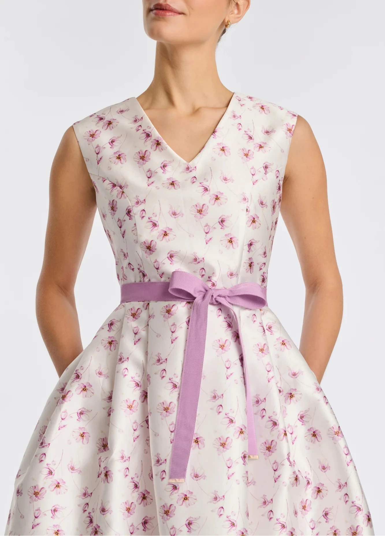 Close-up of sleeveless floral taffeta midi dress with V-neck and lilac contrast belt