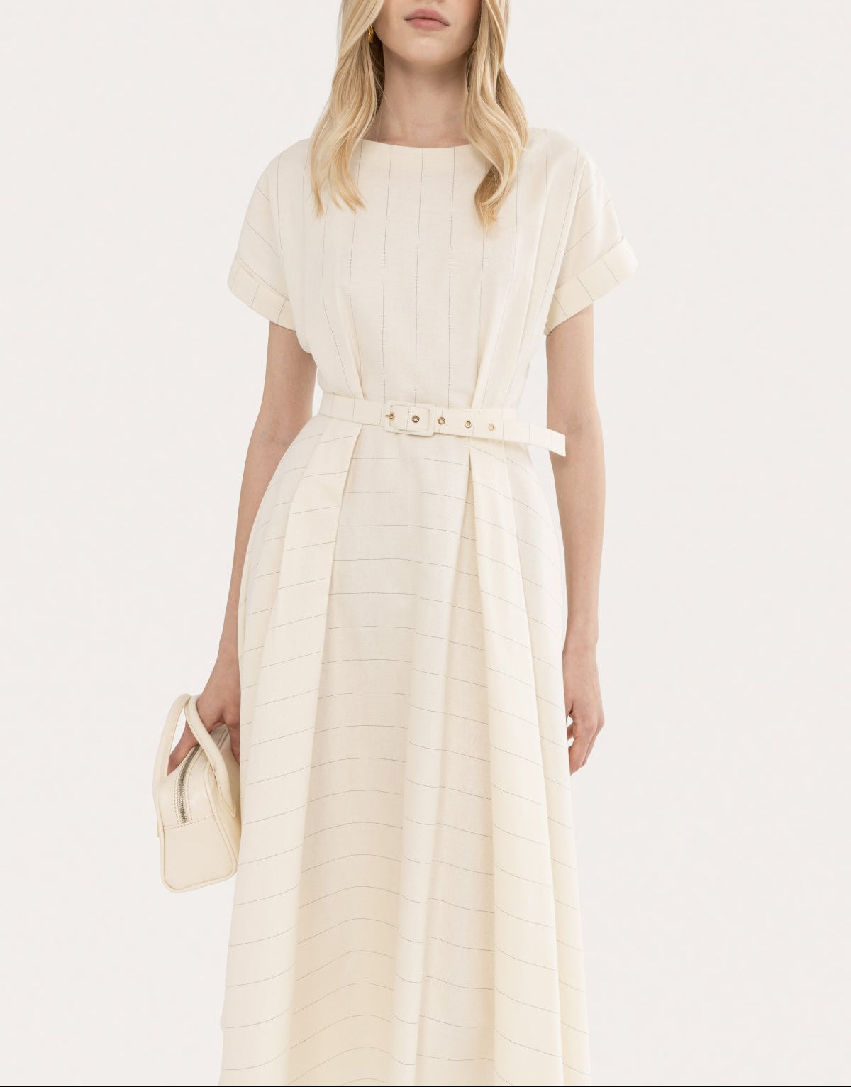 Close-up of an ivory cotton-linen midi dress with soft boat neckline, subtle pinstripes, and matching waist belt
