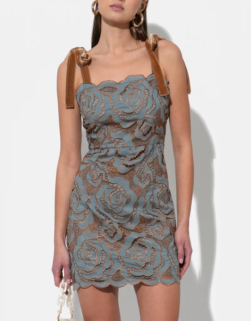 Aqua rose‑lace cocktail mini with velvet tie straps and fitted waist, front on model.