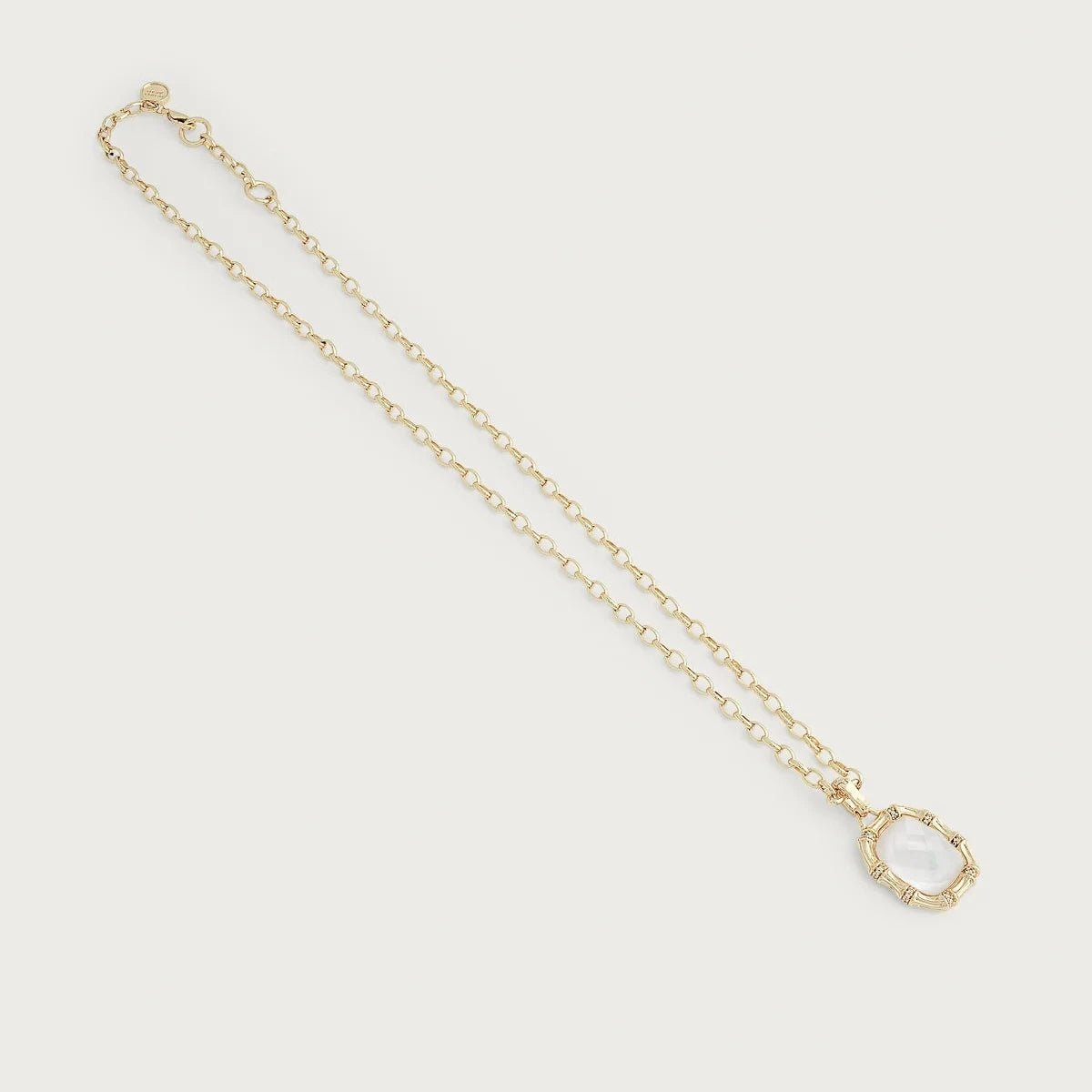 Bamboo with Stone Pendant Necklace by Anabel Aram featuring a faceted mother‑of‑pearl stone framed by gold bamboo segments with pavé crystal accents on an adjustable gold chain.