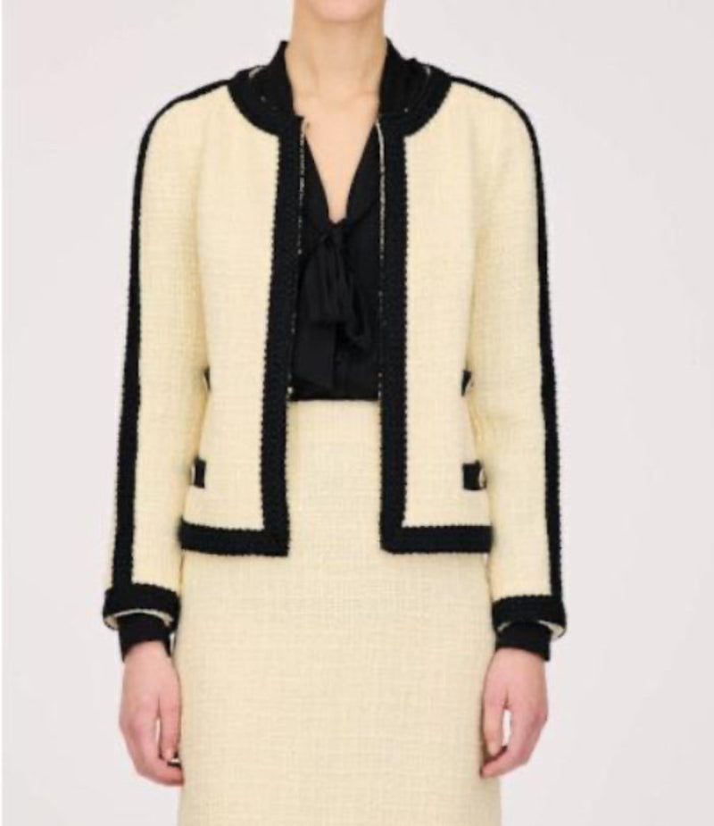 WEILL Paris ecru tweed jacket with black braid trim, worn over a black bow-neck blouse.