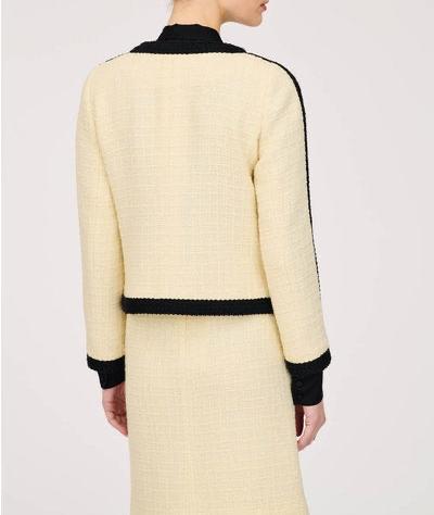 Back of WEILL Paris ecru tweed jacket showing its straight silhouette, black hem braid, and sleeve edging.