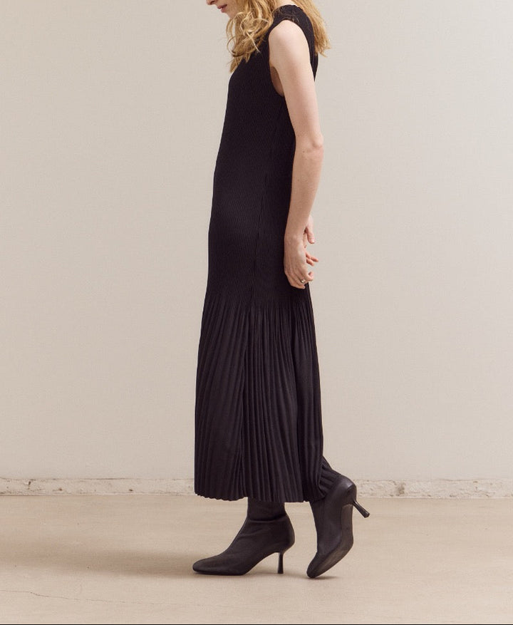Black maxi dress with vertical accordion pleats and sleeveless design by GRADE & GATHER