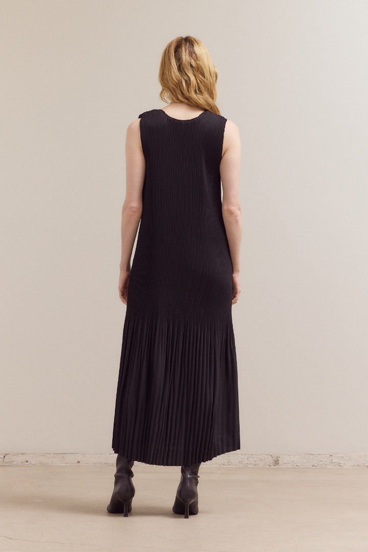 Black wrinkled pleat sleeveless maxi dress by Grade & Gather with vertical pleats and elegant flowing design