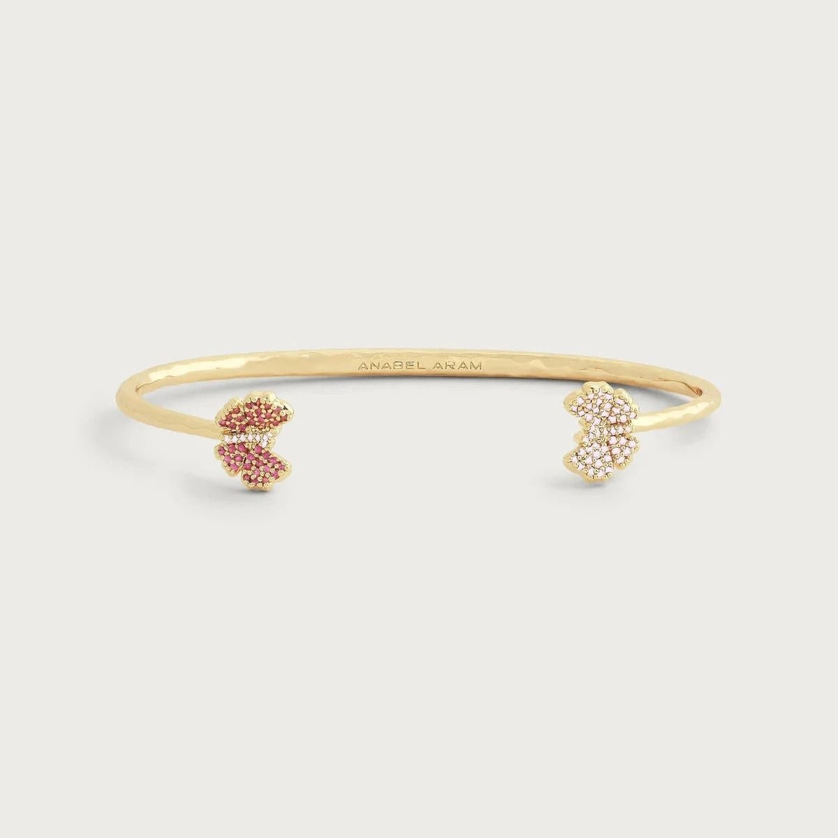 Anabel Aram Butterfly Pink Pavé Bangle featuring a slim hand‑hammered gold bangle with two pavé crystal butterflies at each end.