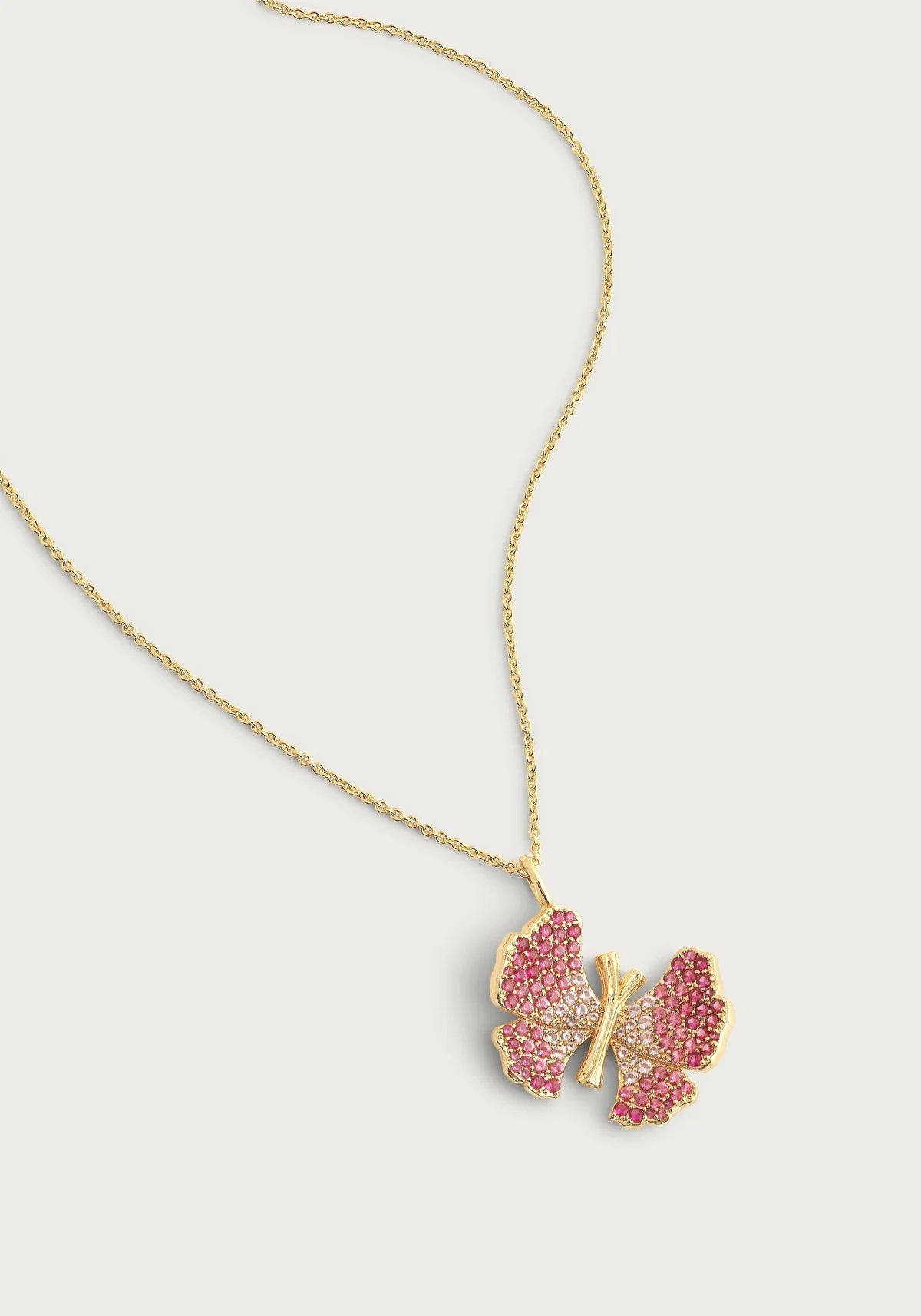 Anabel Aram Butterfly Pink Pavé Necklace featuring a delicate butterfly pendant encrusted with pink crystals on an adjustable gold‑plated chain.
