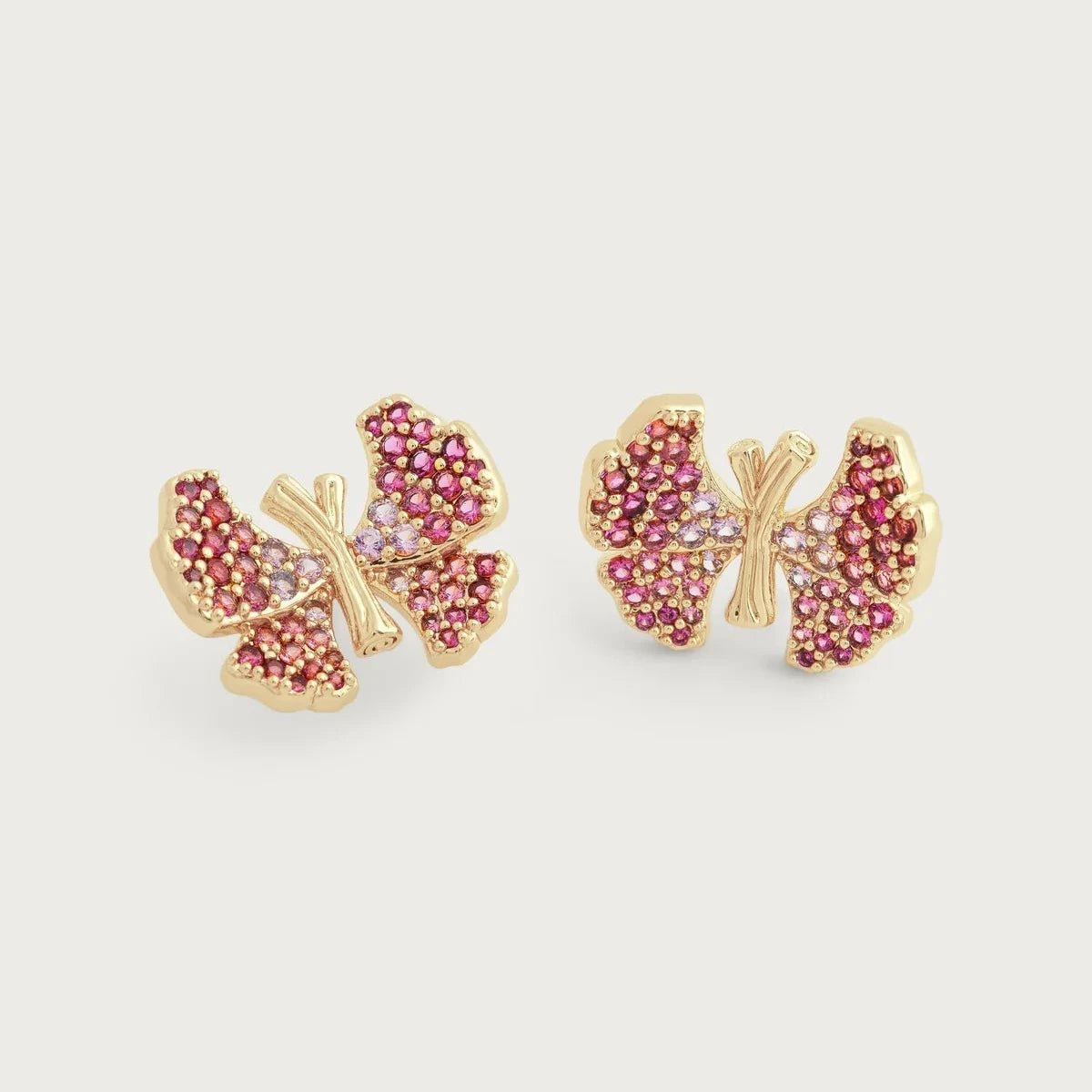 Anabel Aram Butterfly Pink Pavé Stud Earrings featuring petite butterflies crafted from gold‑plated brass and fully encrusted with shimmering pink pavé crystals.