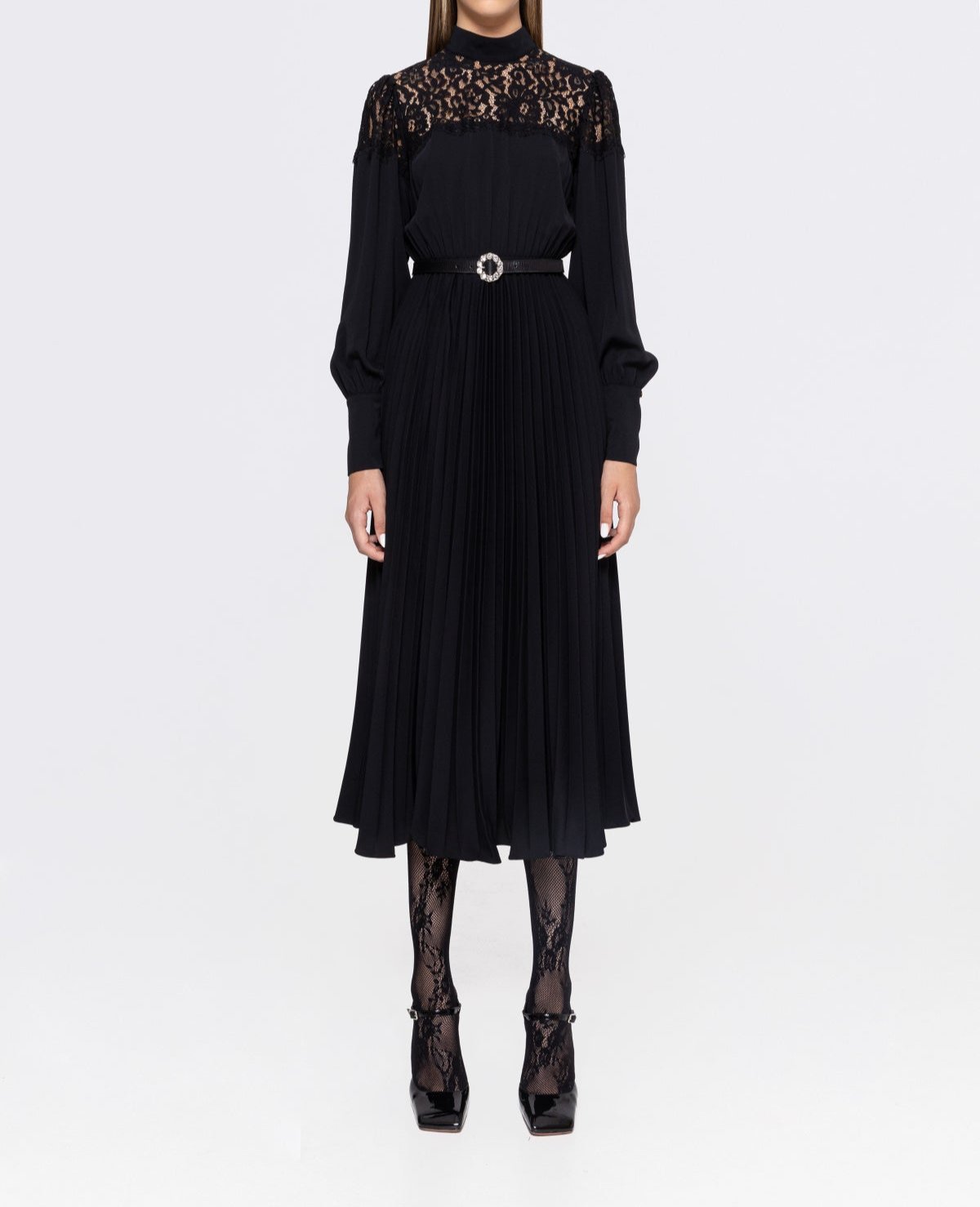 Front view styled with belt showing waist definition on black lace‑yoke pleated midi dress