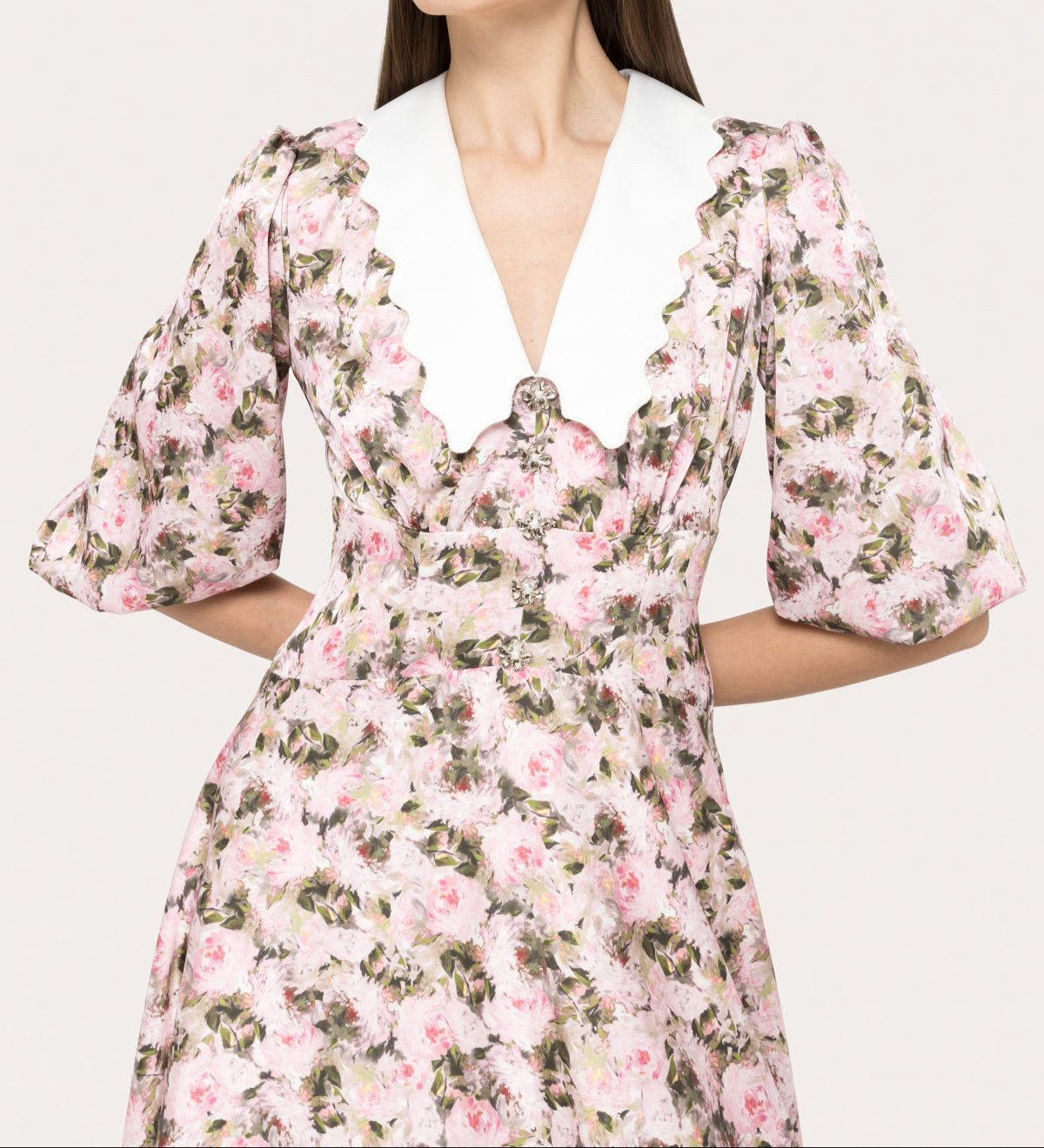 Detail of puff sleeve floral midi dress with waist definition and feminine neckline