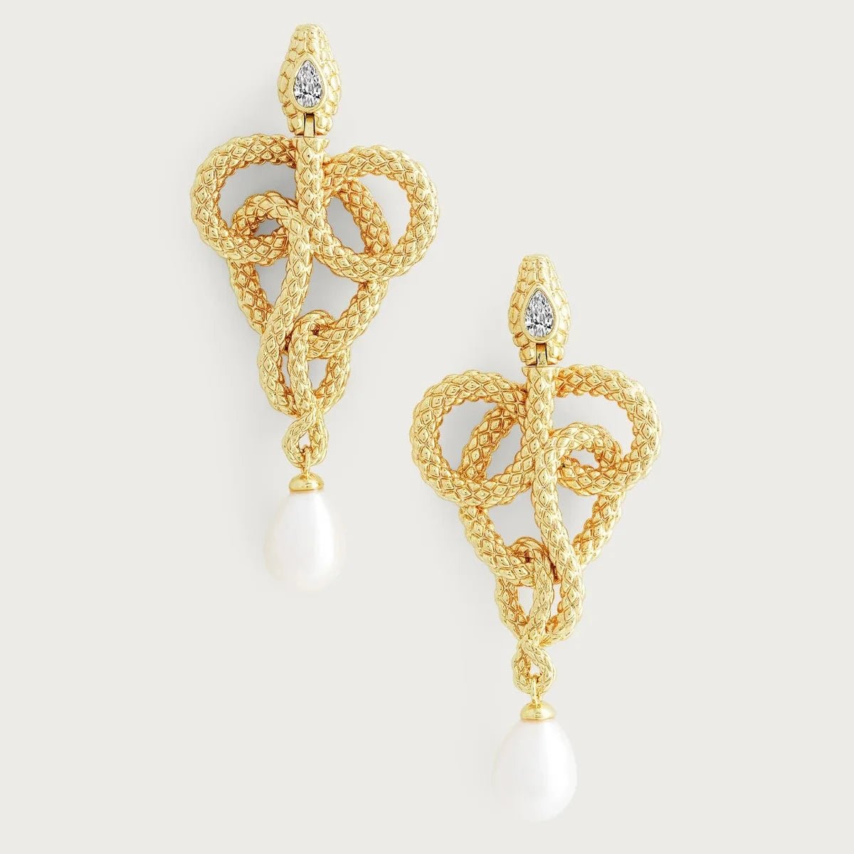 Anabel Aram Serpent Pearl Drop Earrings featuring gold‑plated snake silhouettes with pavé‑set crystals and a dangling pearl drop, measuring approximately 2 inches long.