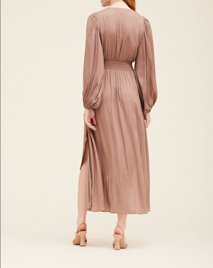 Back view of dusty orchid satin maxi dress showing gathered waist, fluid fabric, and full-length silhouette.