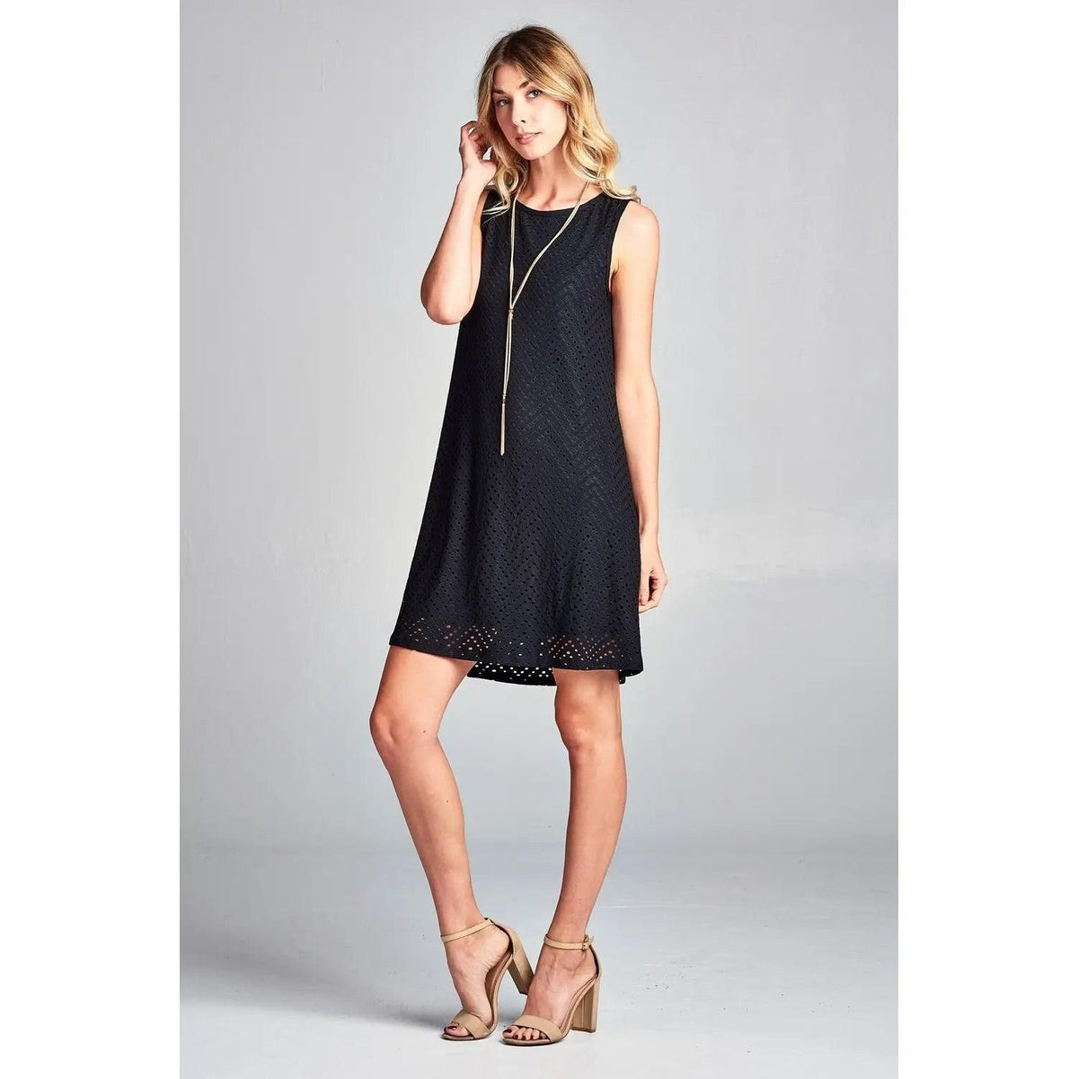 Angled front view of Renee C black sleeveless eyelet mini dress with an A-line shape.