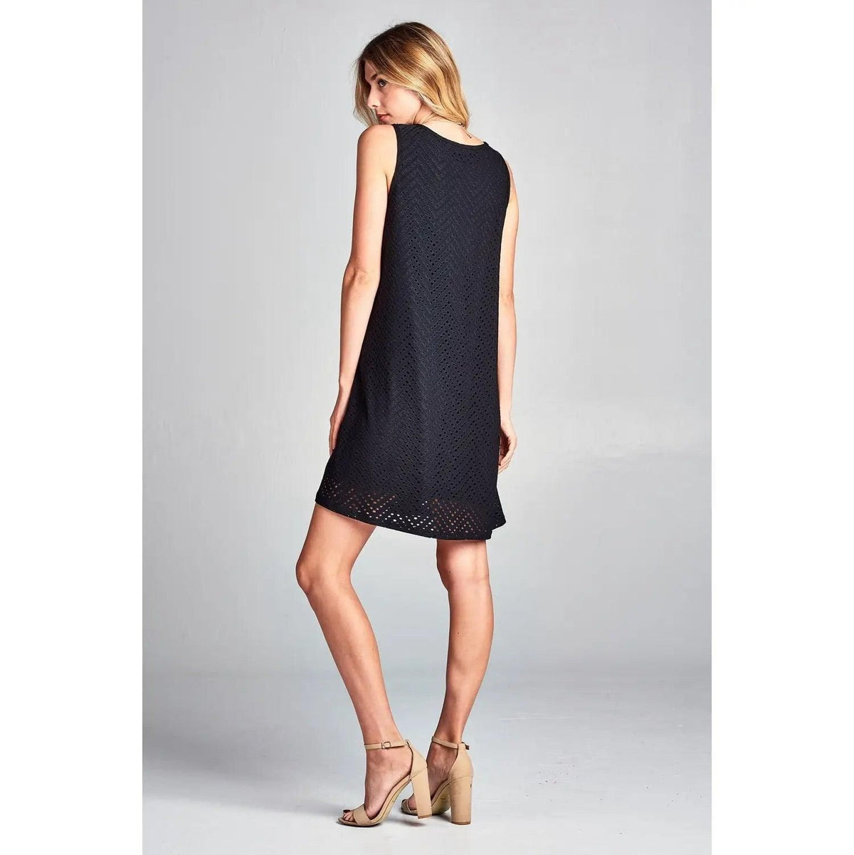 Rear three-quarter view of Renee C black sleeveless eyelet mini dress.
