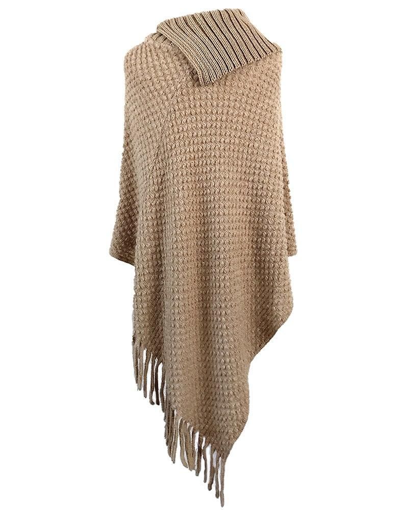 Stylish wool poncho draped over a chair