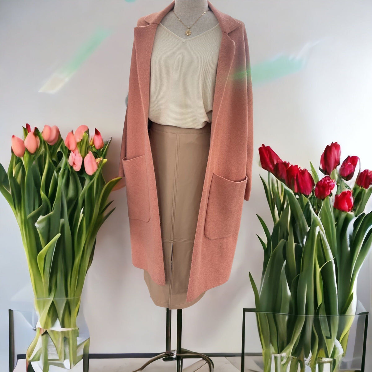 Allie Rose mauve longline knit jacket on a mannequin, styled with an ivory top and nude pencil skirt.