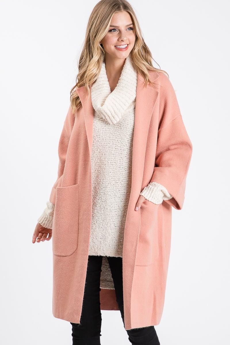 Front view of Allie Rose mauve collared knit jacket with two patch pockets, layered over an ivory sweater and black pants.