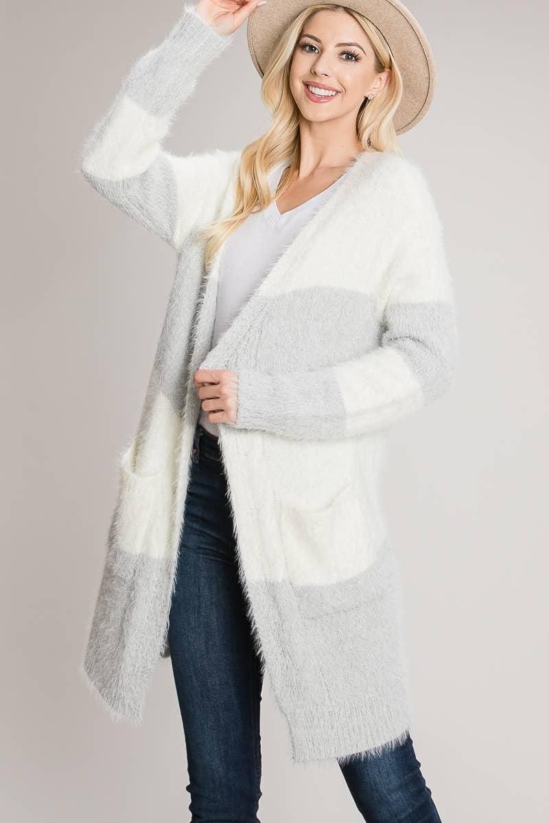 Angled view of the Heather Grey eyelash cardigan showing long sleeves, ribbed cuffs and broad ivory bands.